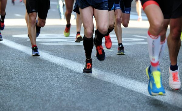 What Role Does Footwear Play in Enhancing Performance for Olympic Distance Runners?